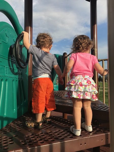 Boy and girl twins at park