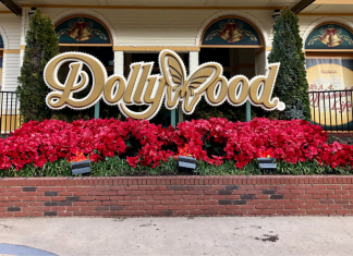 Red flowers in front of the main Dollywood sign on Showstreet at Dollywood Amusement Park