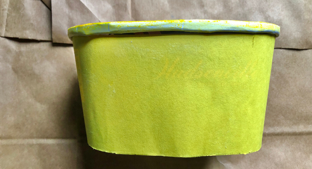 An empty Hudsonville Ice Cream carton covered in yellow construction paper.